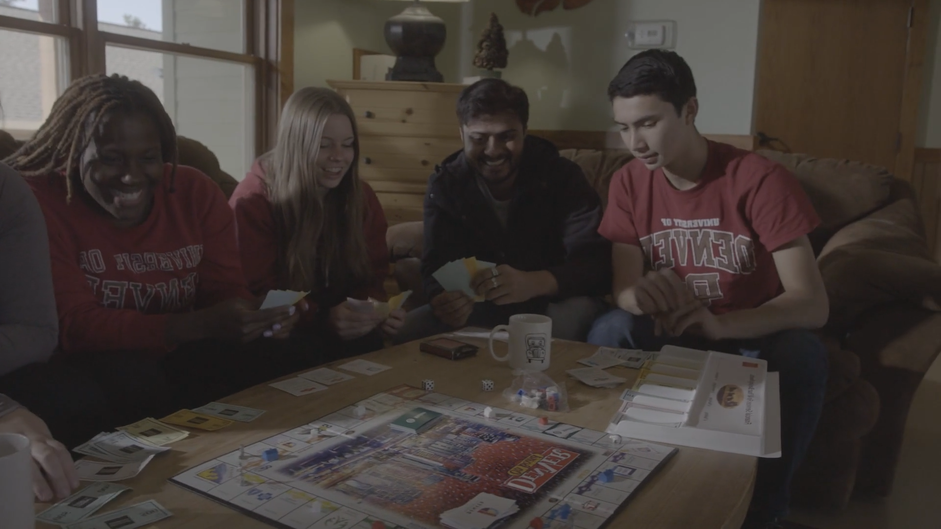 four students playing board game